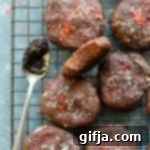 Decadent Chocolate Cherry Chickpea Bites 7 Finished Chocolate Cherry Chickpea Chewies arranged on a cooling rack.