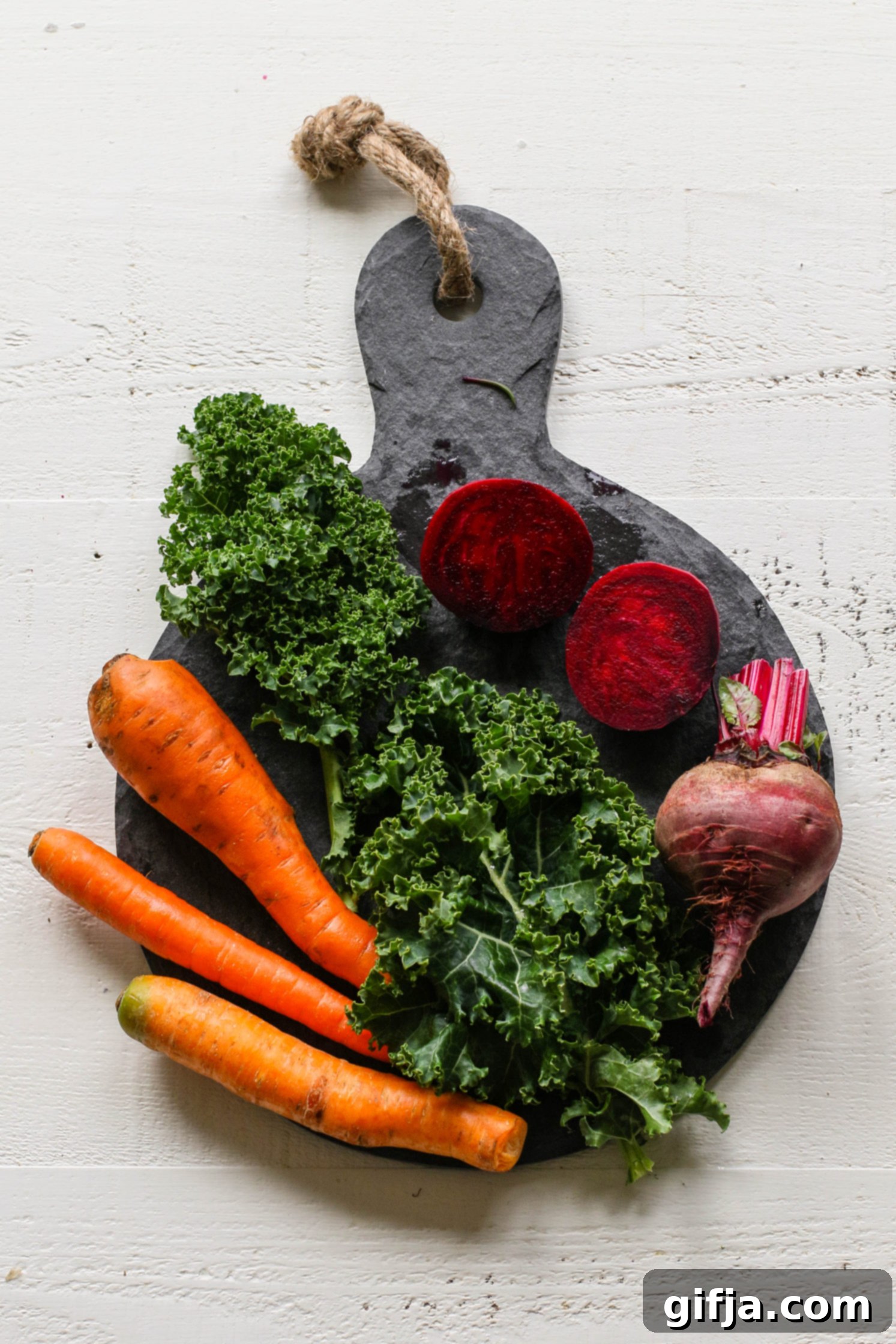 Crimson Root Wellness Bowl 3 carrots, beets, and kale on a serving board by Flora & Vino