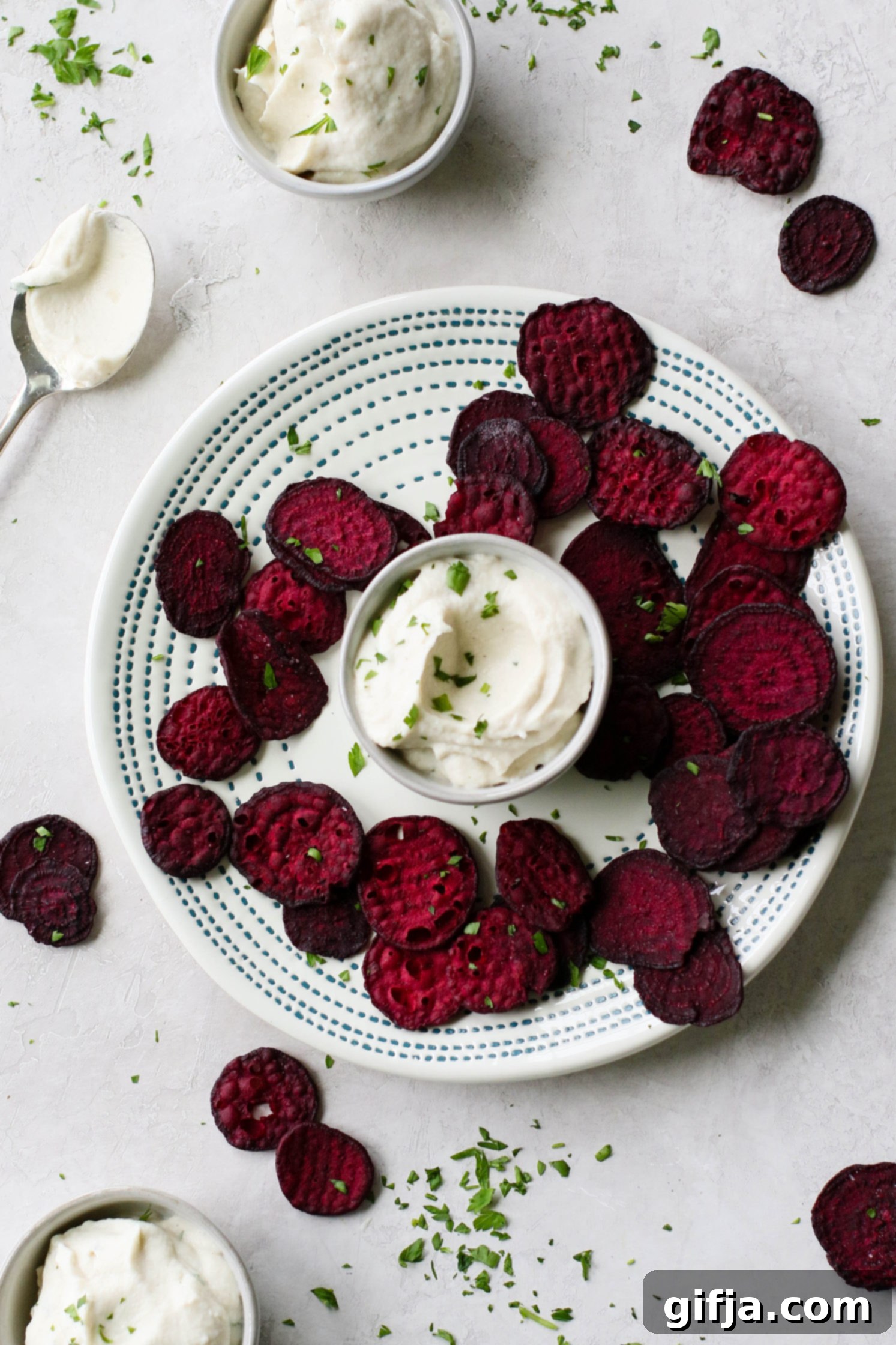 Whipped Cauliflower Dream 2 Creamy Cauliflower Dip served in bowl surrounded by beet chips and fresh parsley