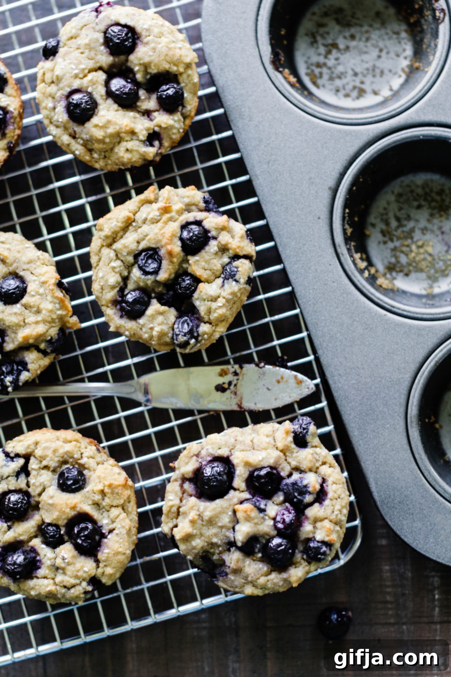 Ultimate Vegan and Gluten-Free Blueberry Muffins 5 The Best Vegan & Gluten Free Blueberry Muffins baked on cooling rack with knife