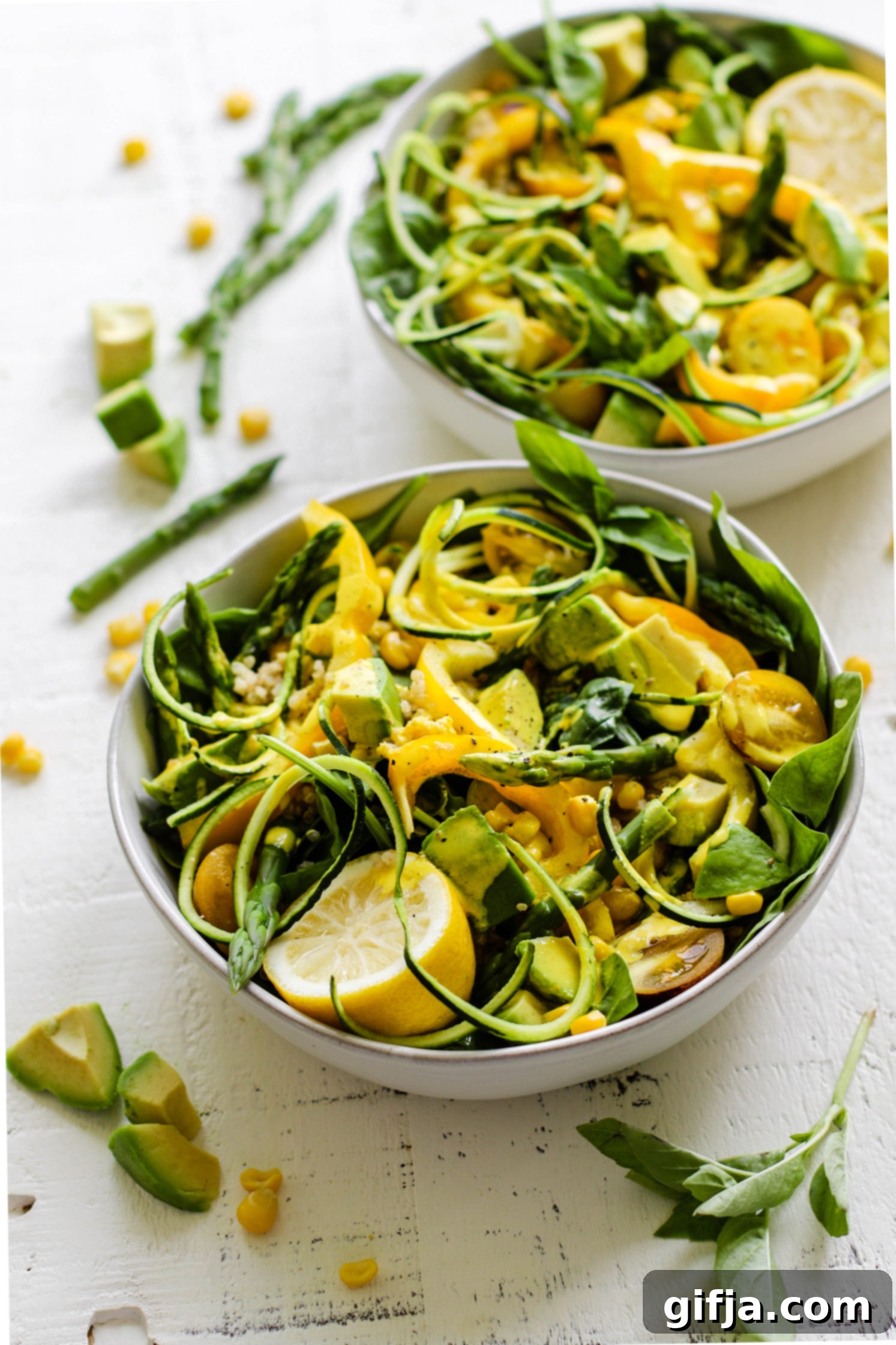 Summer Spinach Salad served in bowls with Turmeric Tahini Dressing 