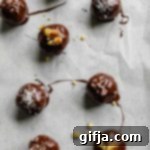Simple 4-Ingredient Superseed Chocolate Truffles 11 A close-up of a single 4-Ingredient Superseed Chocolate Truffle, showcasing its rich texture and topping.