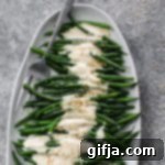 Creamy Oil-Free Dijon Tahini Green Beans 9 Delicious Dijon Tahini Green Beans with a creamy, oil-free dressing, garnished with sesame seeds.