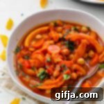 Fragrant Five-Spice Squash and Chickpea Simmer 8 A vibrant bowl of 5-Spice Squash & Chickpea Stew, ready to be enjoyed, garnished with fresh basil.