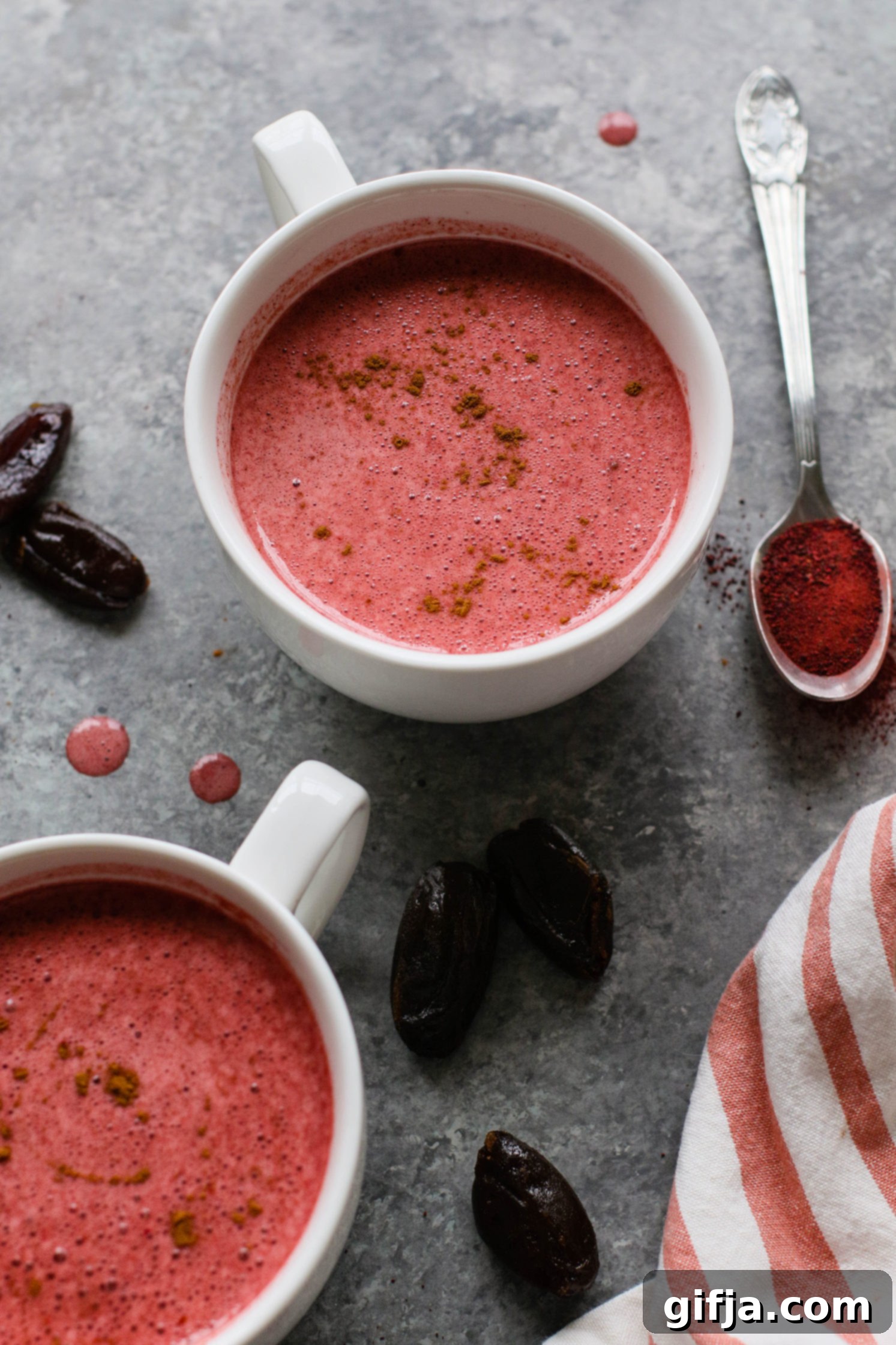 Beet Latte in a glass with a straw