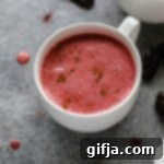 Sun-Kissed Beet N'atte 9 Date-Sweetened Beet Latte in a white mug with a spoon