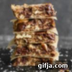Wholesome Wonder Bars 9 Healthy Magic Cookie Bars stacked on serving board by Flora & Vino