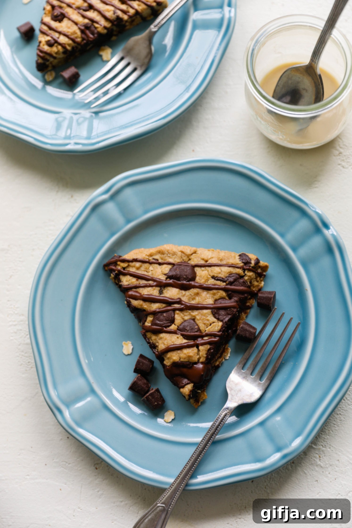 Tahini Swirl Chocolate Oat Scones 13 Oatmeal Tahini Chocolate Chip Scones served on blue plate with dark chocolate chips and a fork with tahini on the side