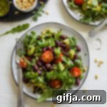 Zesty Arugula Red Bean Salad 8 A close-up of a Kidney Bean Arugula Salad, with ingredients like pine nuts, cherry tomatoes, lemon, and avocado visible, perfect for a quick, healthy vegan meal