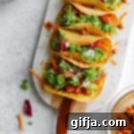 Spiced Roasted Cauliflower & Chickpea Tacos 7 A close-up of a single Cauliflower Chickpea Taco, showcasing the vibrant filling and fresh toppings.