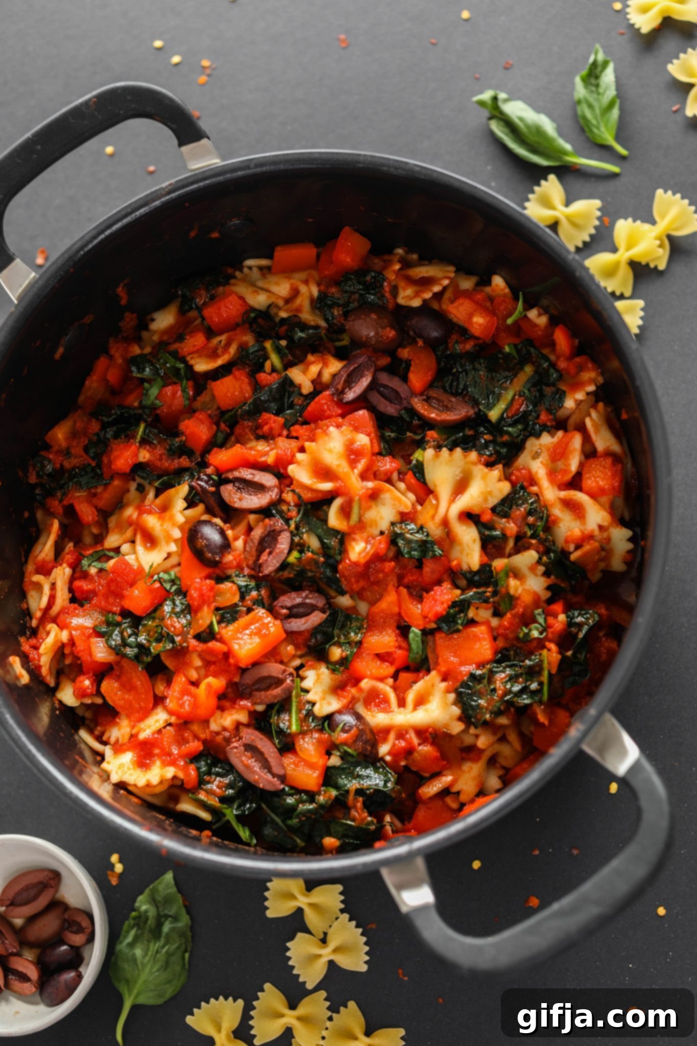 One-Pot Tomato Basil Pasta 13 Vibrant 1-Pot Tomato Basil Pasta in a large sauce pot with fresh basil garnish on a dark background, perfect for quick and healthy meals.