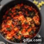 One-Pot Tomato Basil Pasta 9 One-Pot Tomato Basil Pasta in a pot, garnished with fresh basil.