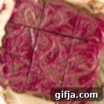Velvet Raspberry Chocolate Cheesecake Squares 15 A delicious slice of Raspberry Swirl Chocolate Cheesecake Bar on a white background, ready to be enjoyed.