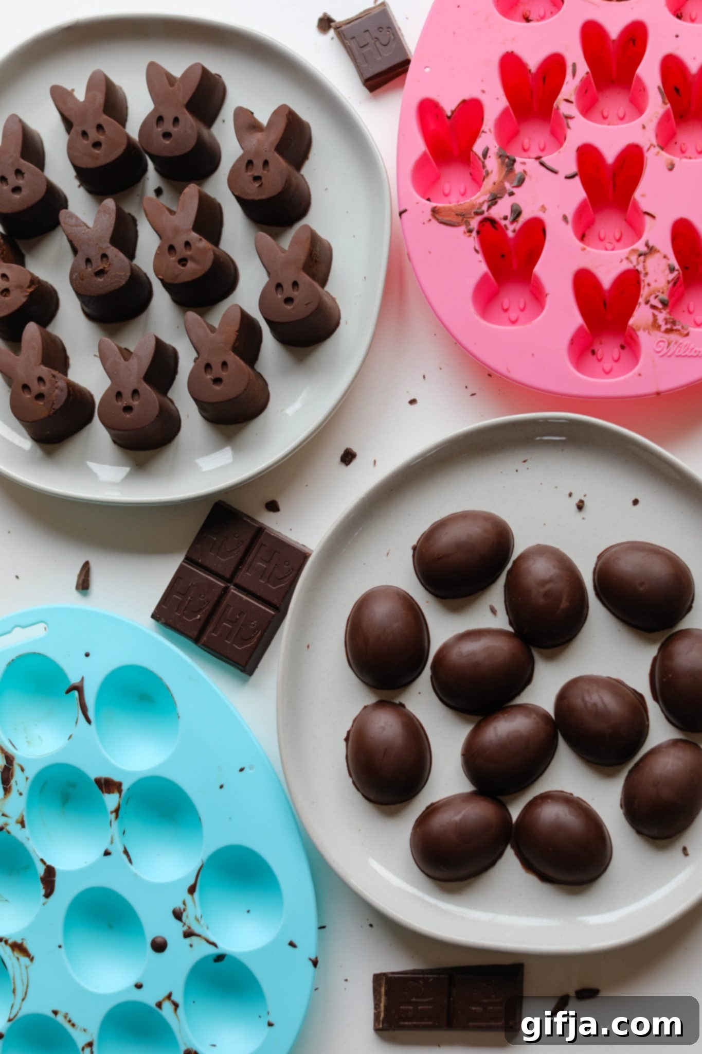 Vegan Chocolate Easter Delights 33 Delicious Homemade Vegan Chocolate Bunnies & Eggs beautifully arranged on white plates next to colorful pink and blue silicone molds by Flora & Vino