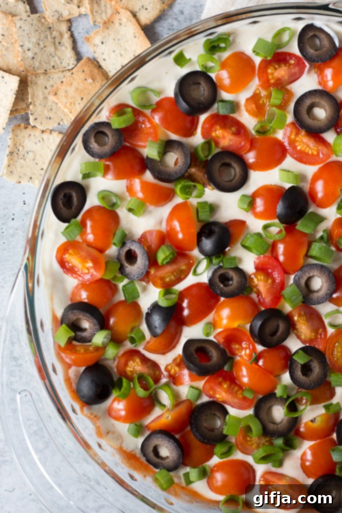 Ultimate Vegan 7-Layer Mexican Dip 37 Delicious Vegan 7-Layer Mexican Dip ready for serving, garnished with fresh ingredients.