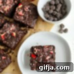 Decadent Dark Chocolate Peppermint Fudge Brownies 12 Dark Chocolate Peppermint Brownies on a plate with candy canes
