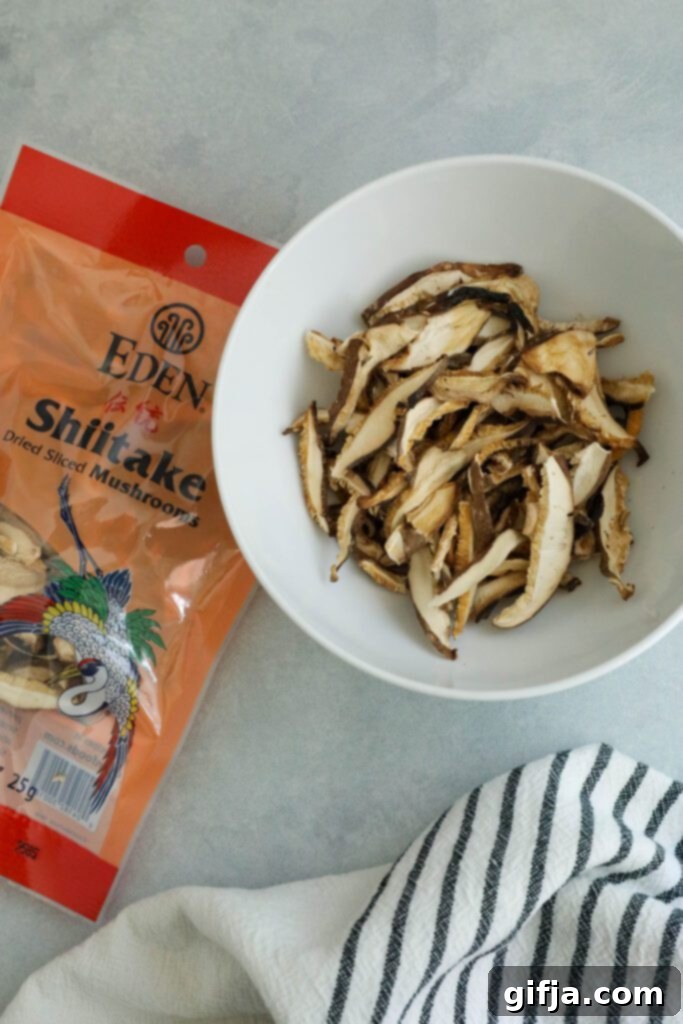 A bowl of high-quality Eden Foods Sliced Dried Shiitake Mushrooms, showcasing their natural, earthy texture, alongside a blue and white striped towel, ready for rehydration.