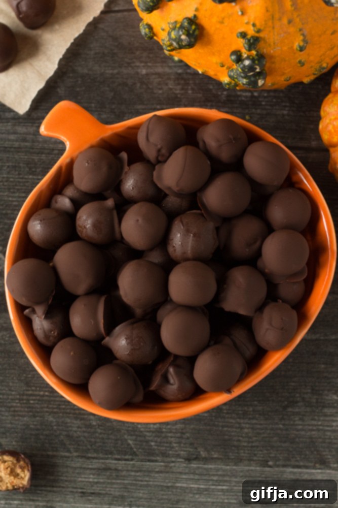 A vibrant display of assorted vegan and gluten-free Halloween treats, including pumpkin-themed candies, chocolate bites, and baked goods, arranged artfully on a festive, dark background.