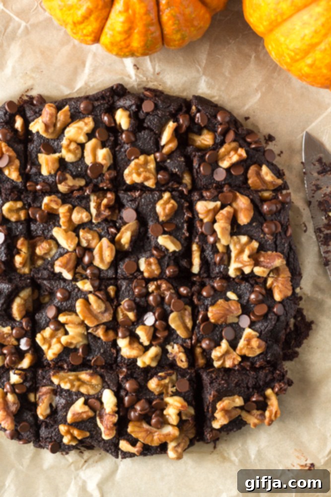 A collection of autumnal and Halloween-themed baked goods, including pumpkin loafs, muffins, and donuts, adorned with festive toppings, all vegan and gluten-free.