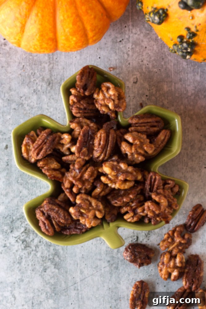 A festive spread of healthy Halloween snacks, including roasted pumpkin seeds, spiced nuts, and fruit dips, arranged with autumn decor.