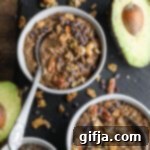 Choco Avocado Chia Dream 11 Creamy Chocolate Avocado Chia Pudding served in a glass bowl with a spoon, garnished beautifully to highlight its rich texture and deliciousness.