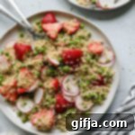 Vibrant Strawberry Quinoa Salad with Zesty Lime Tahini 10 A close-up shot of the vibrant Strawberry Quinoa Salad with a zesty lime tahini dressing, showcasing fresh strawberries, green peas, and herbs.