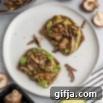 Savory Shiitake Avocado Toast 14 A small image of two Shiitake Avocado Toast pieces on a plate.