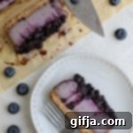 Heavenly Vegan Blueberry Cheesecake 15 Vegan Blueberry Cheesecake sliced on parchment paper