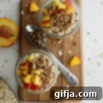 Velvet Peach Overnight Oats 12 Close-up of Peaches 'N' Cream Overnight Oats in a mason jar, topped with fresh peaches and granola.