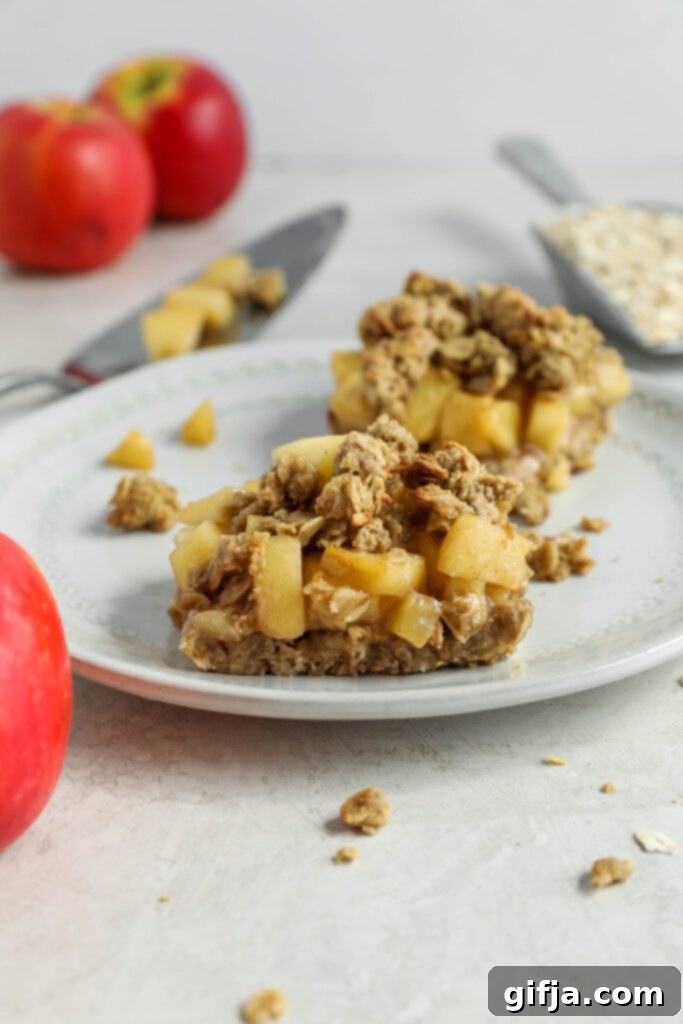 Apple Streusel Bars 4 Apple Pie Crumble Bars on white plate with apples and oats on the side