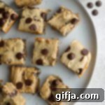 Effortless Blondies 11 A delicious 1-Bowl Blondie with dark chocolate chips on a white plate, ready to be enjoyed.