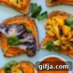 Smoky Roasted Cauliflower Romesco Bites 9 A close-up shot of Romesco Roasted Cauliflower Toasts, showcasing the vibrant colors and appealing texture, with a side of romesco sauce.