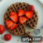 Decadent Vegan Chocolate Waffles 11 A delicious stack of vegan chocolate waffles with strawberries and maple syrup