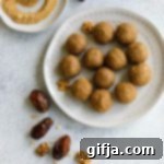 Maple Walnut Wholesome Delights 9 Maple Walnut Bliss Balls rolled in maple sugar on white plates with dates and walnuts scattered