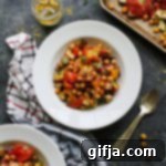 Hearty Vegan Chickpea Ratatouille 9 A close-up shot of a bowl of 1-Pan Vegan Chickpea Ratatouille, ready to be served, highlighting the textures and colors of the roasted vegetables and chickpeas, by Flora & Vino