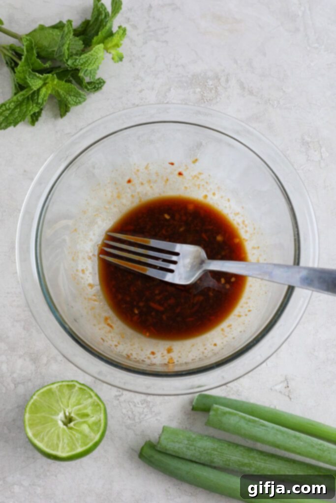 Close-up of the ingredients used for the Coconut Curry Rice Bowl laid out on a table, including spices, liquids, and fresh vegetables.