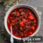 Hearty Beet and Lentil Noodle Stew 8 Delicious one-pot vegan beet and lentil noodle stew in a small bowl