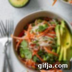 Colorful Noodle Bliss 9 Rainbow Rice Noodle Bowls garnished with avocado, sesame seeds, and cilantro
