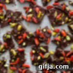 Exquisite Maple Pistachio Goji Berry Chocolate Bark 7 Maple Pistachio Goji Berry Chocolate Bark on a white plate