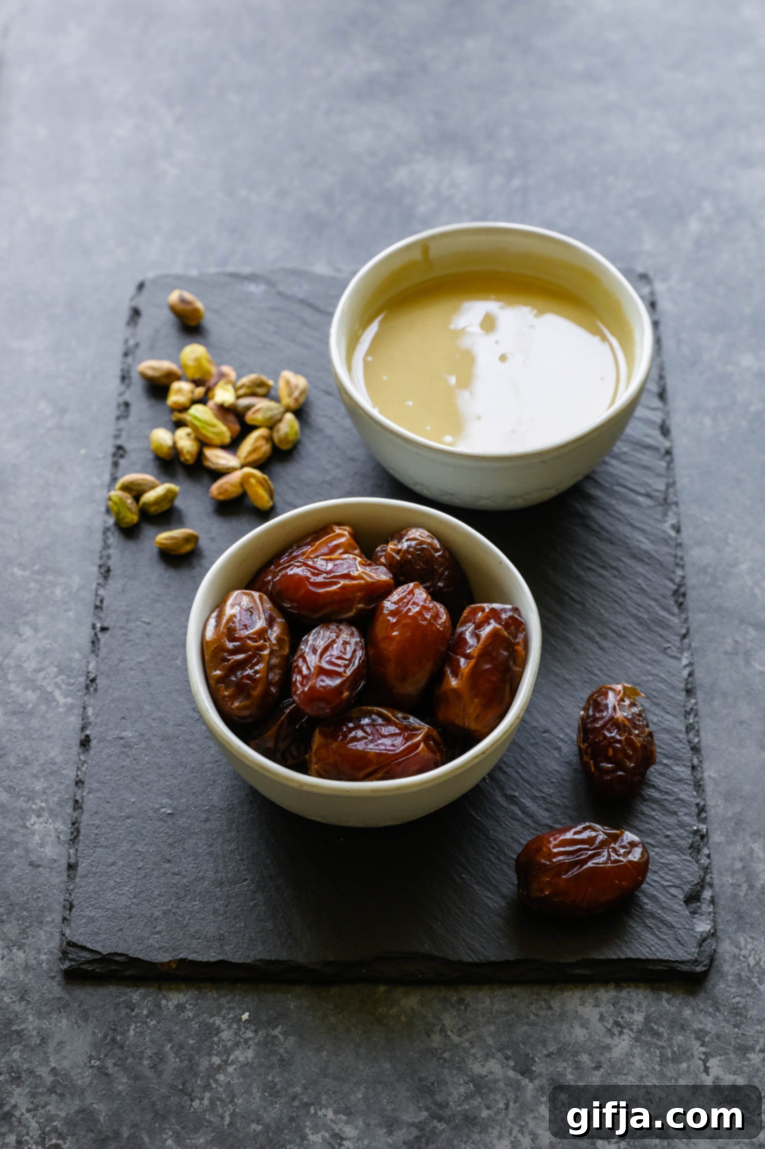 dates, pistachios, and tahini on a serving board by Flora & Vino
