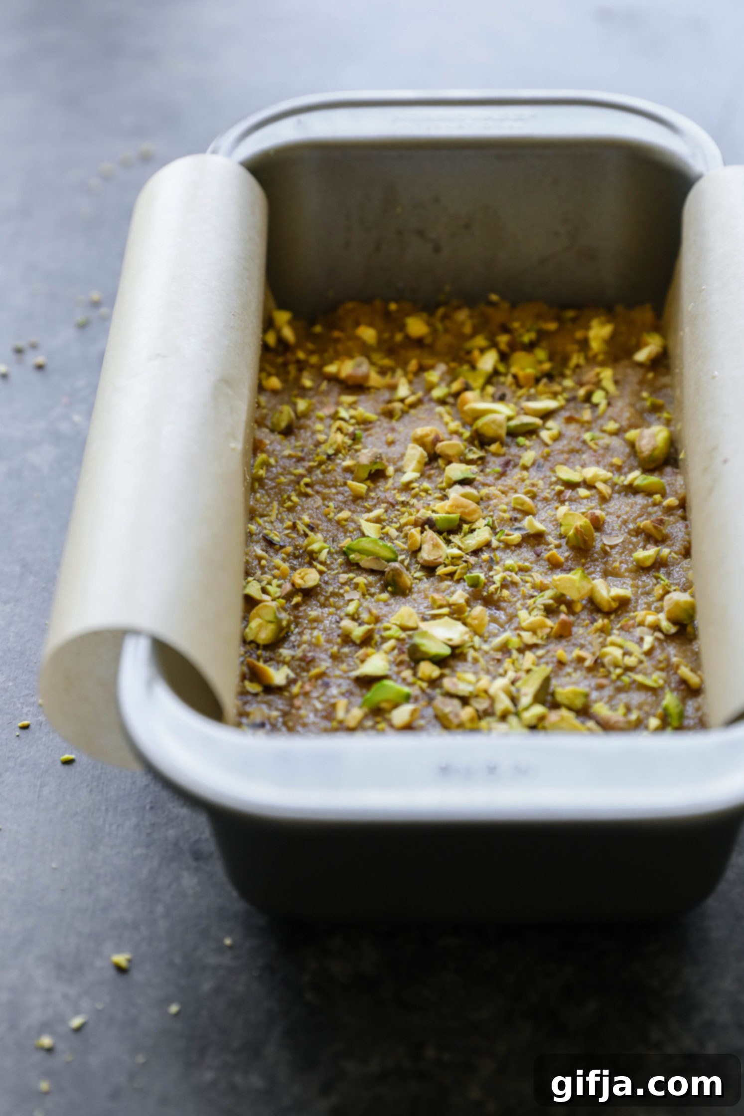 Vegan Tahini Date Halva in parchment lined bread pan by Flora & Vino