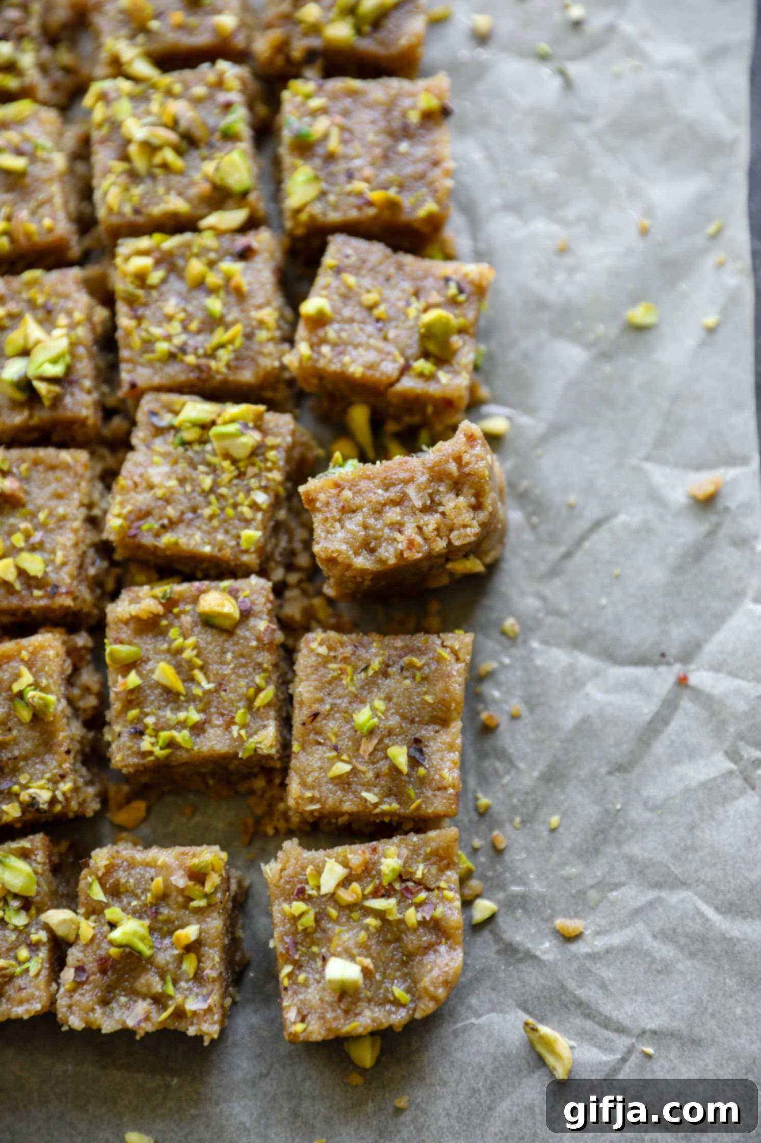 Vegan Tahini Date Halva sliced on parchment paper by Flora & Vino