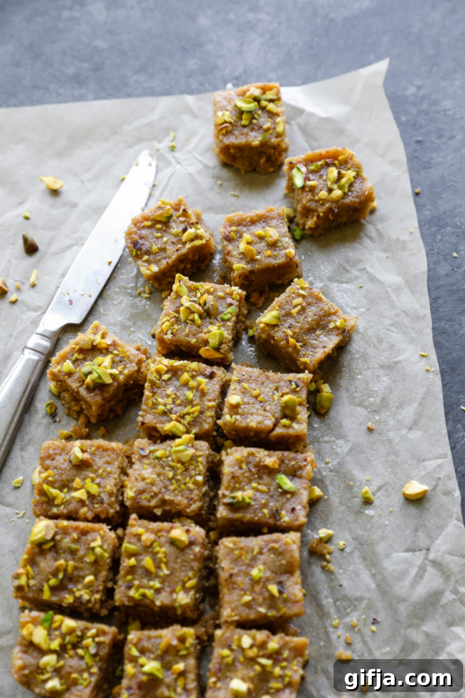Vegan Tahini Date Halva sliced on parchment paper by Flora & Vino