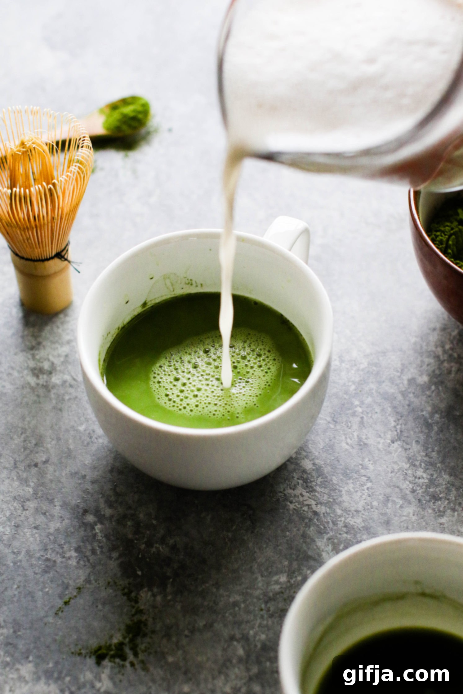 almond milk poured over matcha mug by Flora & Vino 
