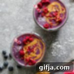 Peanut Butter Jelly and Beet Shakes 11 A top-down shot of a Peanut Butter Jelly & Beet Shake in a mason jar, topped with peanut butter and freeze-dried raspberries, with a vibrant and healthy appearance.