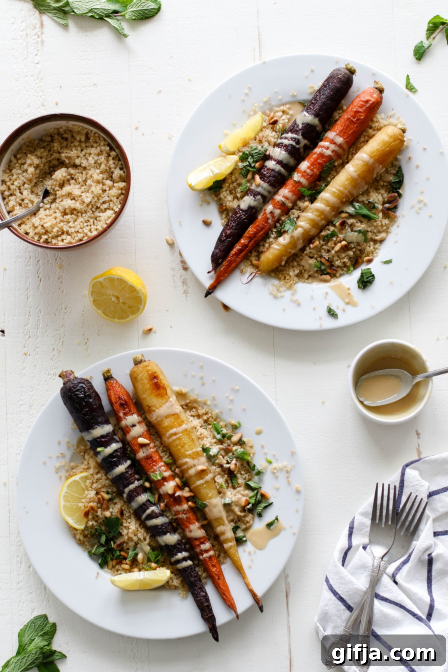 Vibrant Roasted Carrots 2 Rainbow Roasted Carrots served on plates over quinoa with fresh lemon, shredded mint, toasted pine nuts, and drizzle of tahini