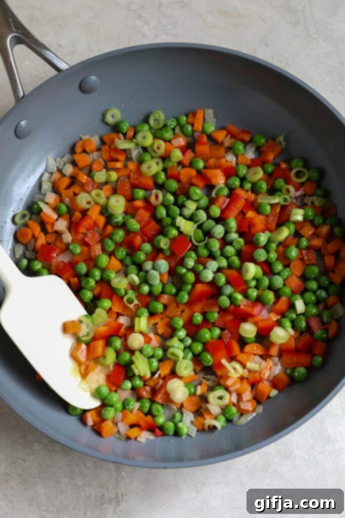 Solo Fried Rice Delight 5 chopped vegetables in skillet with spatula