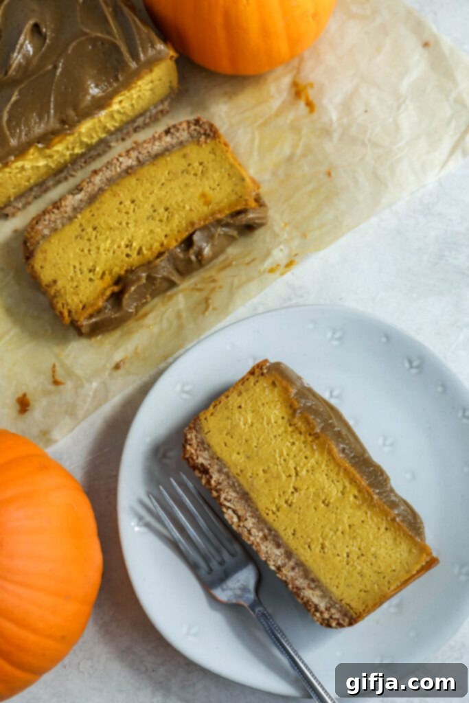 Spiced Pumpkin Cheesecake with Silky SunButter Frosting 2 slices of Pumpkin Pie Cheesecake with SunButter Frosting on plate with fork, garnished with cinnamon