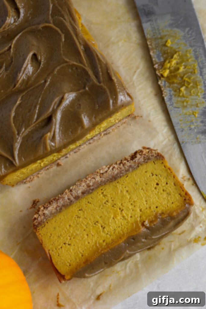 Spiced Pumpkin Cheesecake with Silky SunButter Frosting 12 Pumpkin Pie Cheesecake with SunButter Frosting on parchment lined board, close up