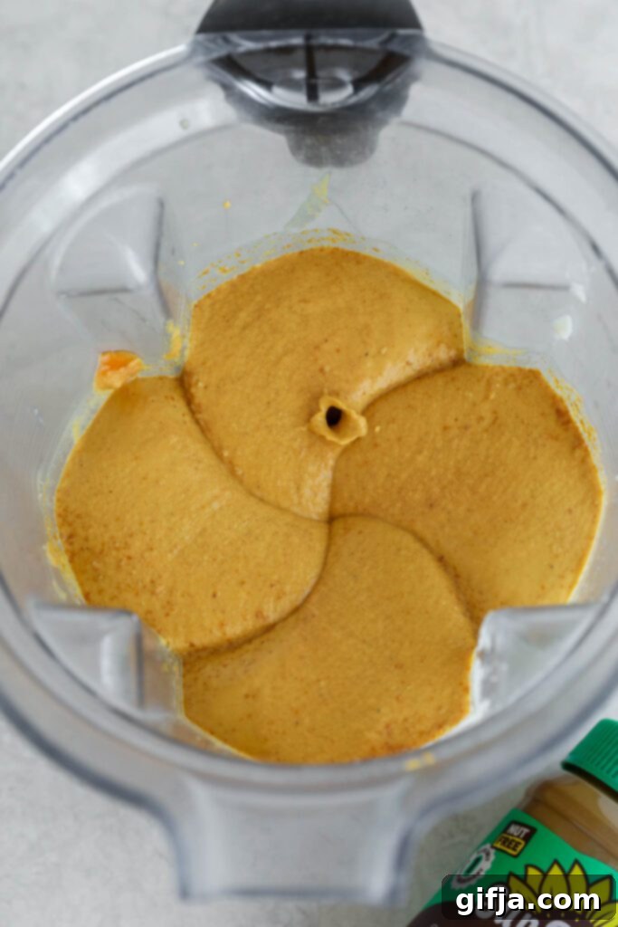 Spiced Pumpkin Cheesecake with Silky SunButter Frosting 6 ingredients for pumpkin pie filling in blender, showing finished blend